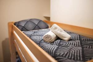 a bed with a towel and a pillow on it at Vikendica Tarzini dvori - privatnost na 2000m2 in Tomislavgrad