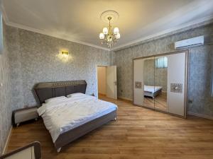 a bedroom with a large bed and a mirror at Burj Sheki in Sheki