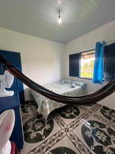 a bedroom with a hammock in the middle of a room at Canto da Sereia - Casa in Soure