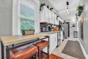 a kitchen with white cabinets and a wooden counter top at Serenity House 2BR Central Location in ATL in Atlanta +18 photos