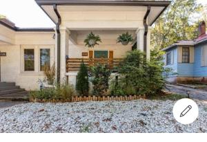 a white house with a porch and a driveway at Serenity House 2BR Central Location in ATL in Atlanta