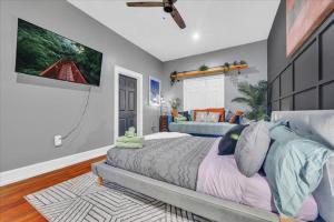 a bedroom with a large bed and a tv at Serenity House 2BR Central Location in ATL in Atlanta