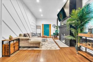 a living room with a couch and a fireplace at Serenity House 2BR Central Location in ATL in Atlanta