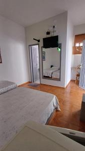a bedroom with a large mirror and a bed at Hotel Mar de Minas in Três Marias