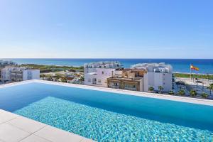 a swimming pool with a view of a city and the ocean at Un Sueño Realidad En Torrox in Los Llanos