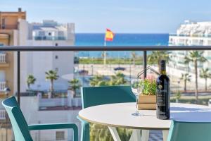 a bottle of wine sitting on a table with a glass at Un Sueño Realidad En Torrox in Los Llanos