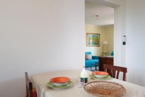 a dining room table with two bowls on it at Agriturismo Agricola Cassiano in Morciano di Leuca