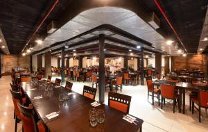 a dining room with wooden tables and chairs at San Miguel Plaza Hotel All Inclusive in Villa San Miguel