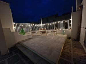a patio with chairs and a fence at night at Residenza Storella 18 in Alessano