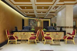 a lobby with a waiting room with chairs and a table at Royal Maxim Palace Kempinski Cairo in Cairo
