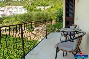 a balcony with a table and chairs on a balcony at Rosemary Apartment in Promajna