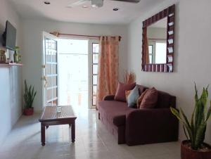 a living room with a couch and a table at Casa Itzae in Valladolid