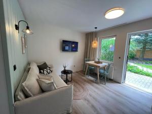 a living room with a couch and a table at Bungalow Green Park in Benz