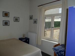 a bedroom with a bed and a window at Guest house Adonis in Bruges