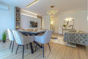 a dining room with a table and blue chairs at Dioro Luxury Residence Budapest- Steps from the Danube ,free parking in Budapest