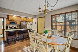 a kitchen and dining room with a table and chairs at Lazy Dayz by Avada Properties in Pigeon Forge