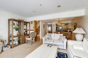 a living room with a couch and a table at Indian Harbor Villas -- 31 Indian Harbor in Bethany Beach