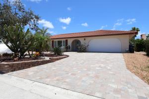 a house with a driveway and a garage at Siesta Key Island Rentals in Siesta Key