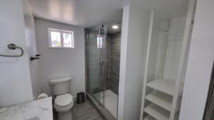a bathroom with a toilet and a glass shower at Waterside Serenity in Hudson +18 photos