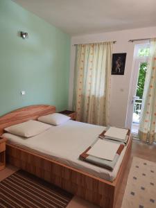 a bedroom with a large bed and a window at Apartmani Marijela in Orebić