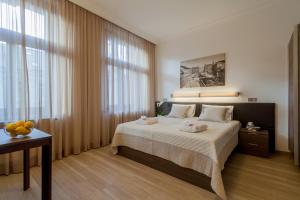 a bedroom with a bed with towels on it at VINOHRADSKY DUM Residence in Prague