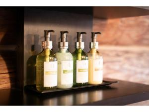 a row of wine bottles sitting on a shelf at Fiore Shima - Vacation STAY 25660v in Shima +12 photos