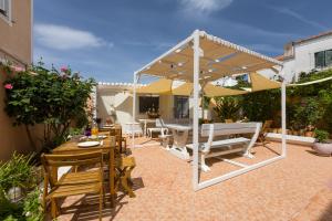 a patio with a table and chairs and an umbrella at Spetses Center Comfy Apartment in Spetses
