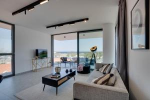 a living room with a couch and a table at Sea View Central Deluxe Gaia 302 in Larnaka