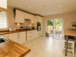 a large kitchen with white cabinets and a table at Spicery in Exeter