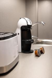 a coffee maker sitting on a counter next to a sink at Apartamentos enfrente del Museo Dalí - Serena Stays in Figueres