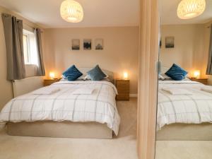 a bedroom with two beds and a mirror at Spicery in Exeter