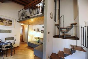 a living room and dining room with a couch and stairs at Acacia Apartments Salvia-Rosmarino in Florence