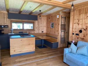 a kitchen with a table and a couch in a room at Chalet Obstblüte in Glonn