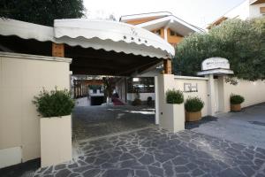 a entrance to a building with an awning and plants at Villa Alba Boutique Hotel in Pescara