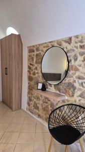 a room with a mirror on a stone wall at Lithino in Líthion