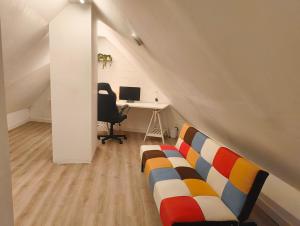 a room with a couch and a desk with a computer at Penthouse Apartment in Central Oxford in Oxford +14 photos