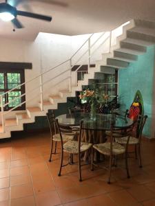 a dining room with a table with chairs and a staircase at Casa Fragatas in Ixtapa in Ixtapa
