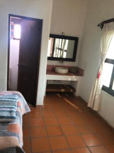 a bathroom with a sink and a mirror at Casa Fragatas in Ixtapa in Ixtapa