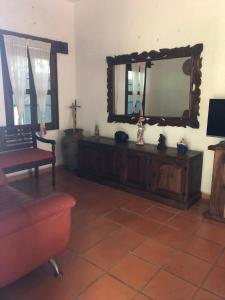 a living room with a couch and a mirror at Casa Fragatas in Ixtapa in Ixtapa
