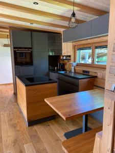 a kitchen with wooden counters and a wooden table at Chalet Obstblüte in Glonn +12 photos