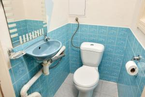 a blue tiled bathroom with a toilet and a sink at Old Town & Parking Assistance in Prague +43 photos