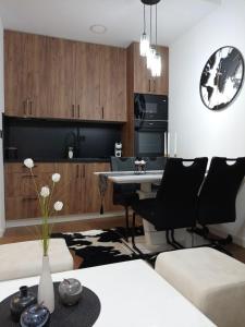 a kitchen and living room with a table and chairs at Apartman Mišić Zlatibor in Zlatibor +50 photos