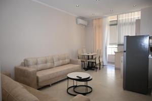 a living room with a couch and a table at Eleana's Apartament in Sarandë
