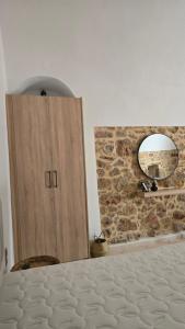 a wooden door in a room with a mirror at Lithino in Líthion +18 photos