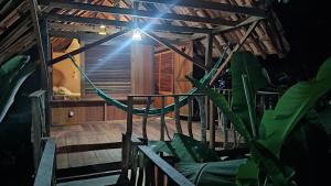 a room with a hammock in a house at Suíte Curuaçu in Santarém
