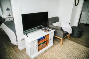 a living room with a flat screen tv and a chair at House-1 Bedroom, 1 Bath-Private, Centrally Located in Kalispell
