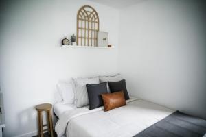 a white bed with black pillows in a room at House-1 Bedroom, 1 Bath-Private, Centrally Located in Kalispell