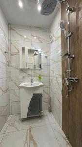 a bathroom with a sink and a shower at First Line Apartment 2 in Balchik +12 photos