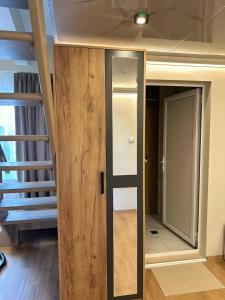 a room with a wooden door and a staircase at First Line Apartment 2 in Balchik
