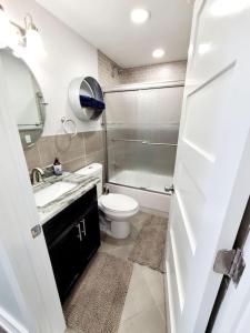 a bathroom with a toilet and a sink and a shower at Charlies by the Bay Unit 4 in New Baltimore
